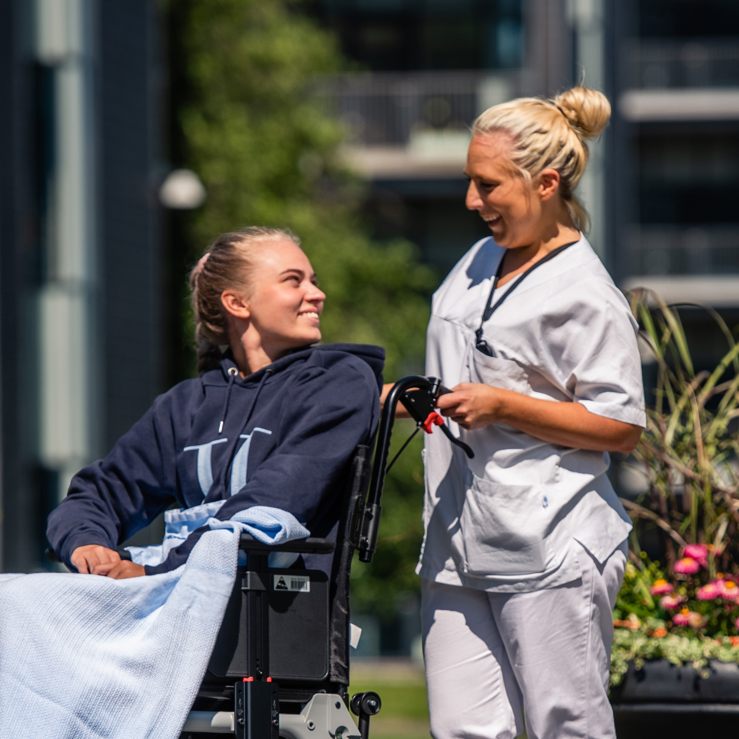 A woman pushing a girl in a wheelchair