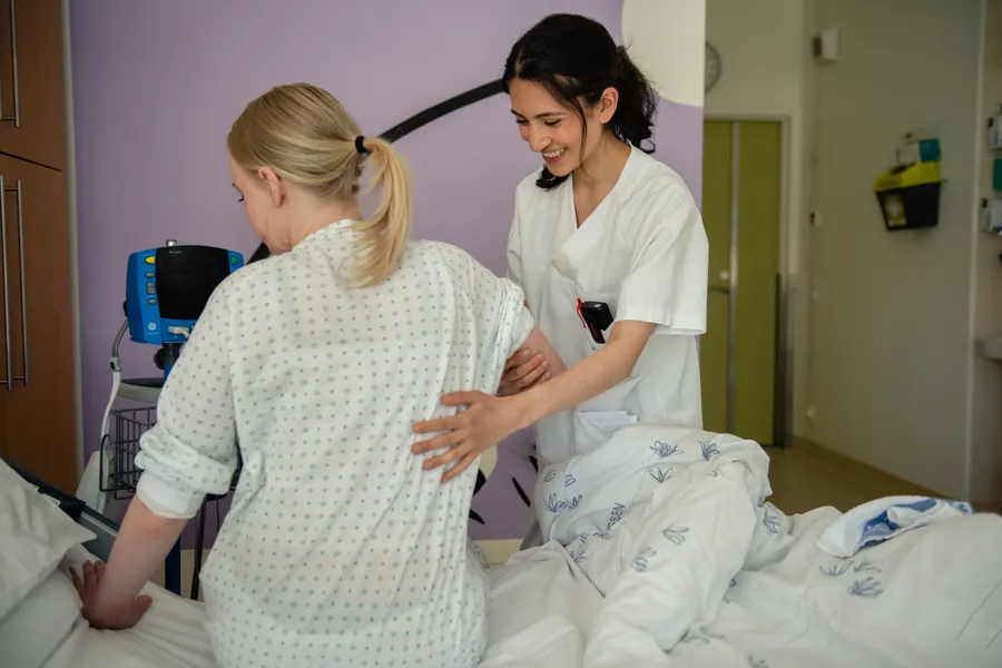 A nurse checking a patient's pulse