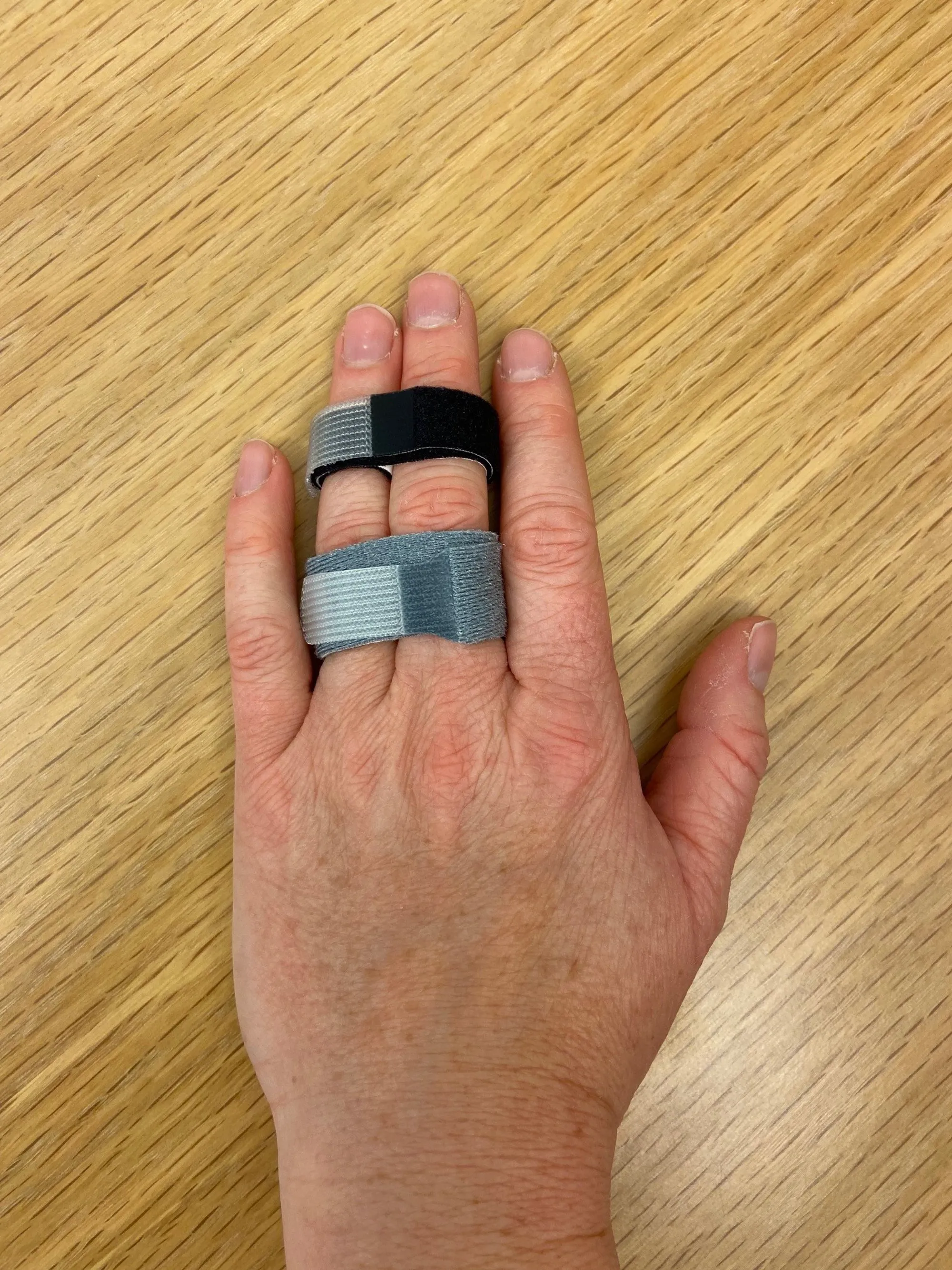 A hand holding a small metal object