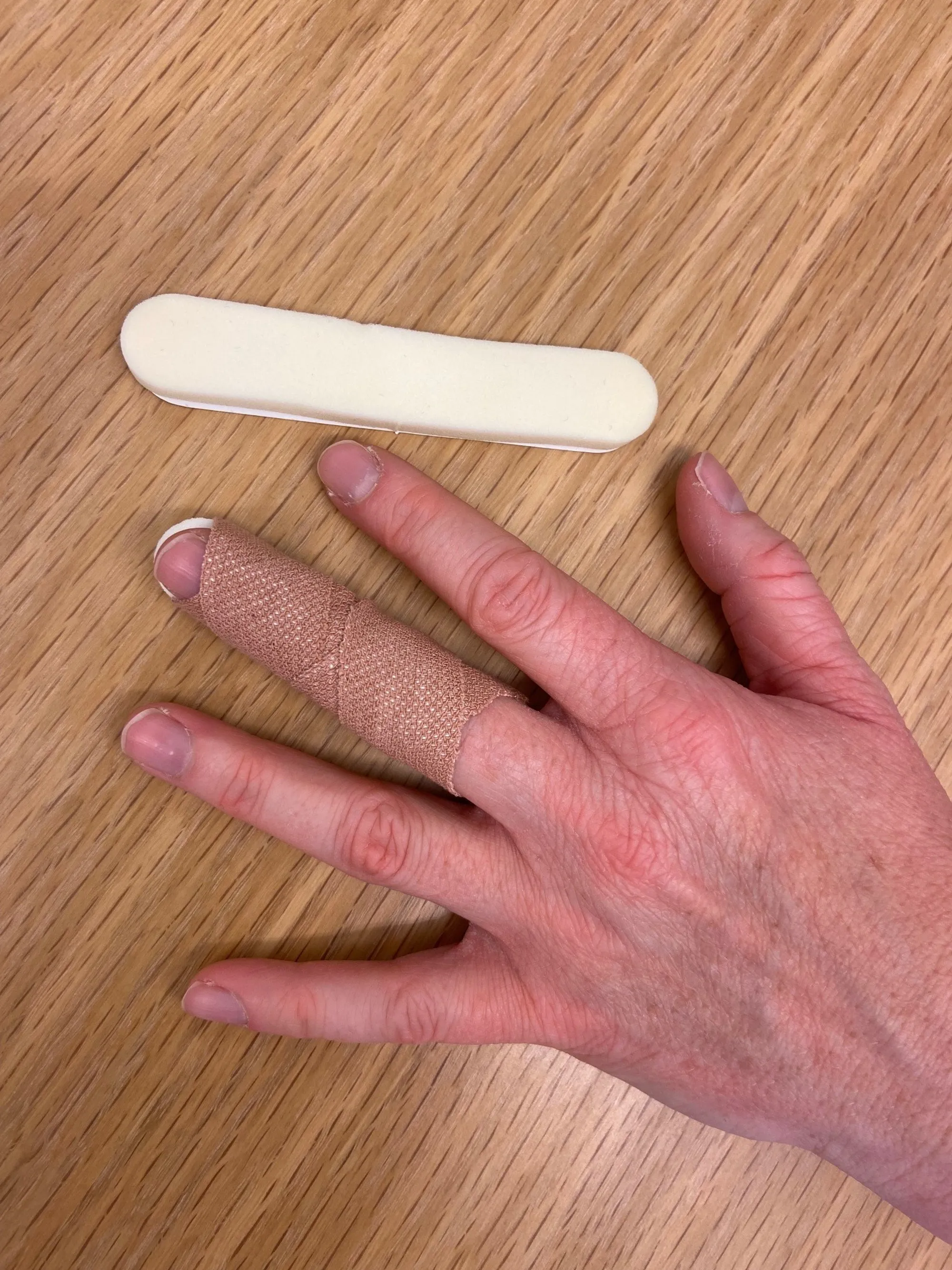 A person's hand holding a white object