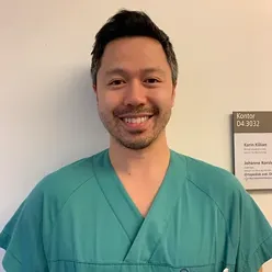 En mann som smiler til kameraet