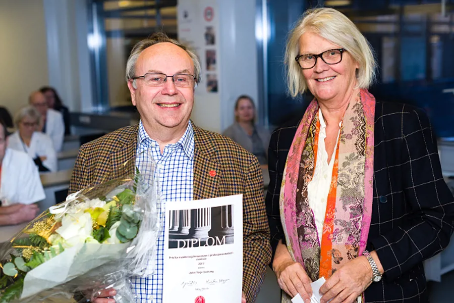 Prodekan Ingrid Os deler ut Pris for kvalitet og innovasjon i profesjonsstudiet i medisin til Professor II Jonn Terje Geitung på